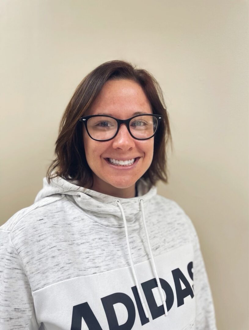 A woman wearing glasses and a sweatshirt.